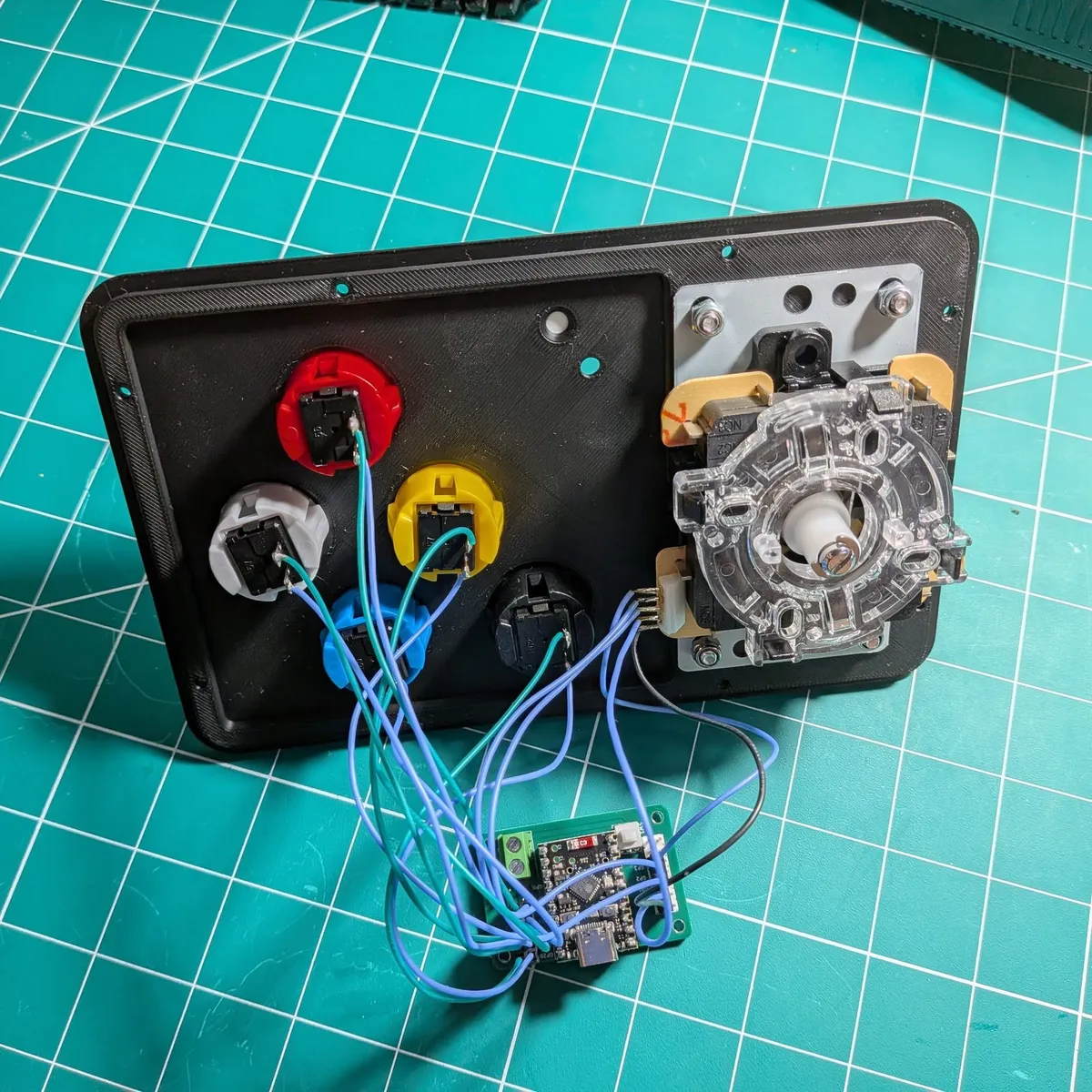 Underside of the Arcade Remote top panel, with the joystick and five buttons wired to the small controller board